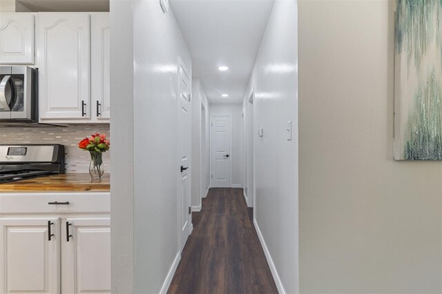 hallway with dark wood-type flooring