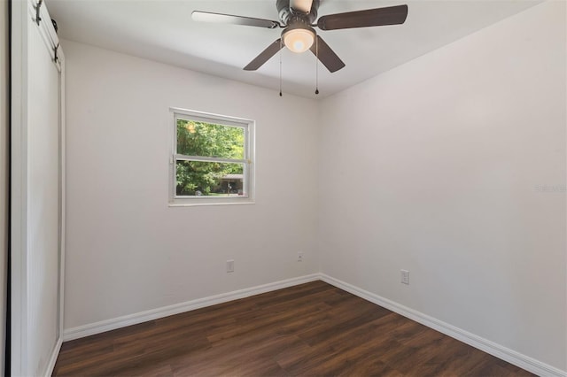 spare room featuring ceiling fan and dark wood-type flooring