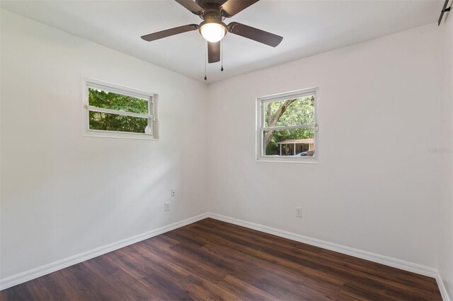 spare room featuring ceiling fan and dark hardwood / wood-style floors