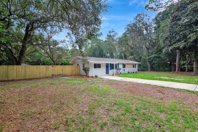 single story home featuring a front yard and covered porch