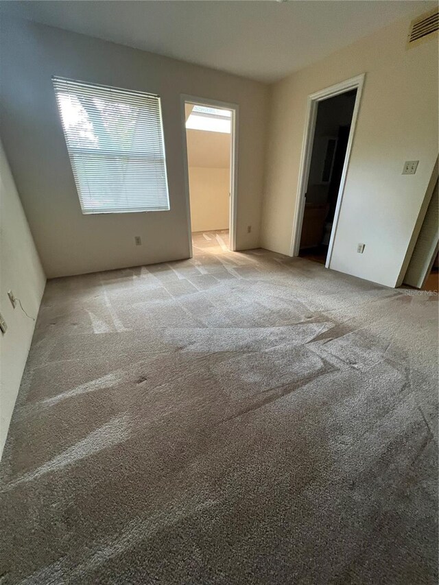 empty room featuring carpet and plenty of natural light