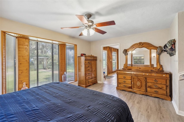 bedroom featuring ceiling fan, light wood-type flooring, and access to outside