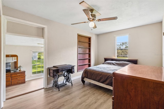 bedroom with light hardwood / wood-style flooring and ceiling fan