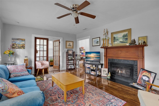 living room featuring ceiling fan and hardwood / wood-style flooring