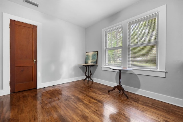 empty room featuring dark hardwood / wood-style flooring