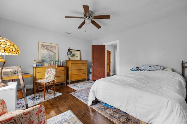 bedroom with dark hardwood / wood-style flooring and ceiling fan