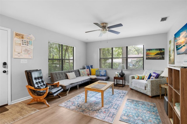 living room featuring ceiling fan and wood-type flooring