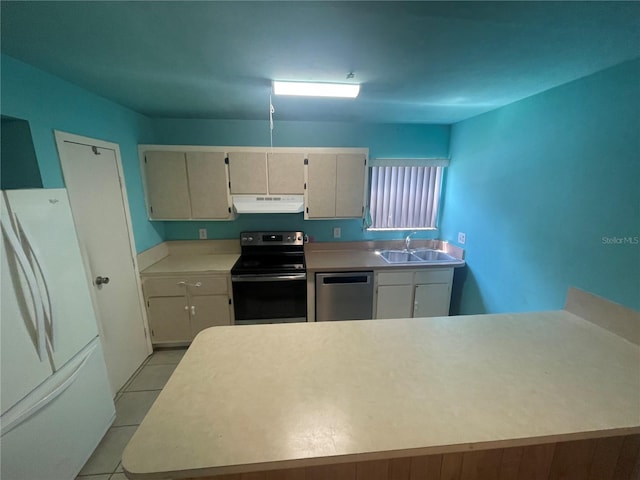 kitchen with sink, stainless steel appliances, and light tile patterned flooring