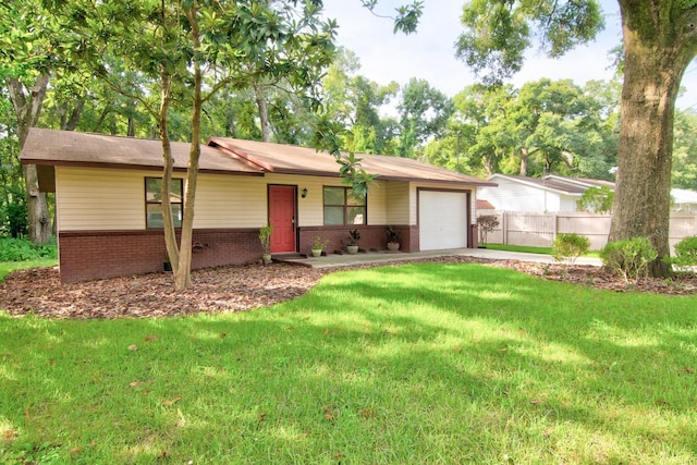 ranch-style house featuring a garage and a front yard