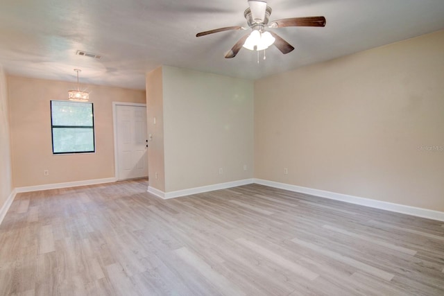 spare room with ceiling fan and light wood-type flooring