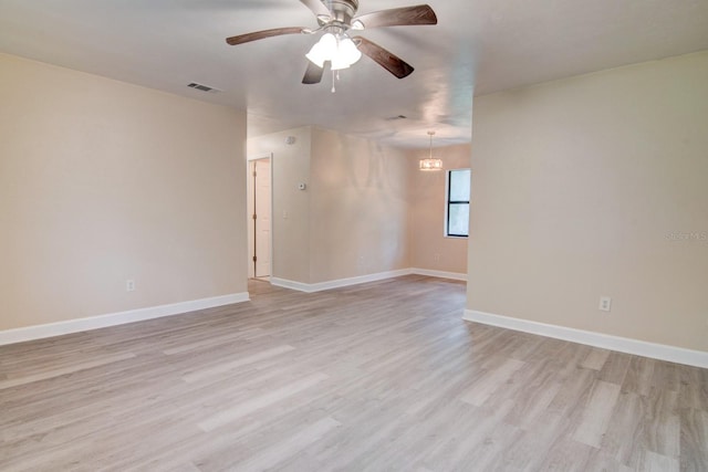 spare room with light wood-type flooring and ceiling fan