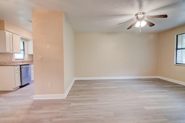 interior space featuring sink, ceiling fan, and light wood-type flooring