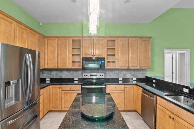 kitchen featuring dark stone counters, tasteful backsplash, appliances with stainless steel finishes, and light tile patterned flooring