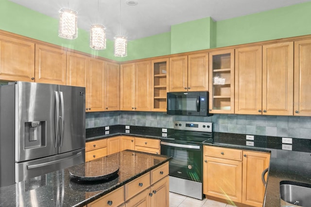 kitchen featuring stainless steel appliances, dark stone counters, light tile patterned floors, decorative light fixtures, and decorative backsplash