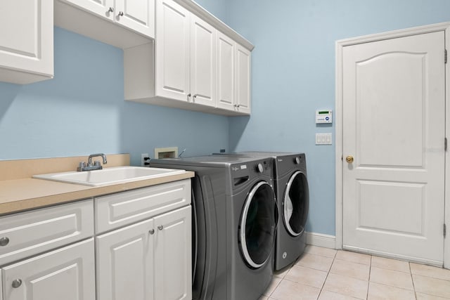 washroom with cabinets, light tile patterned flooring, sink, and independent washer and dryer