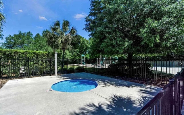 view of pool featuring a patio and an in ground hot tub