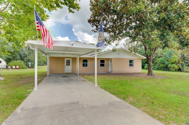 view of front of house featuring a front lawn and a carport