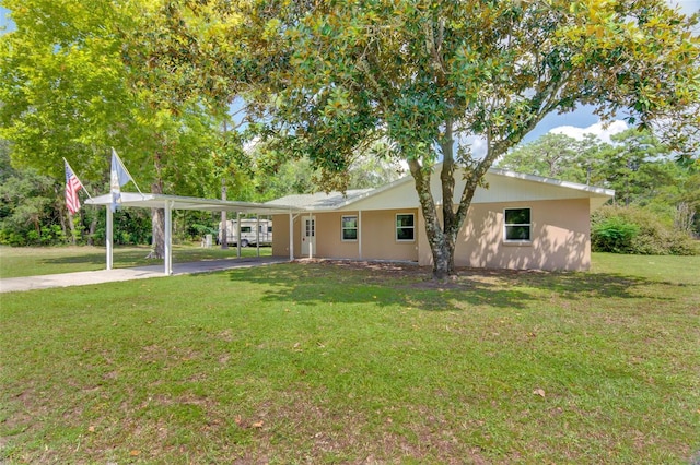 view of front of house with a front lawn and a carport