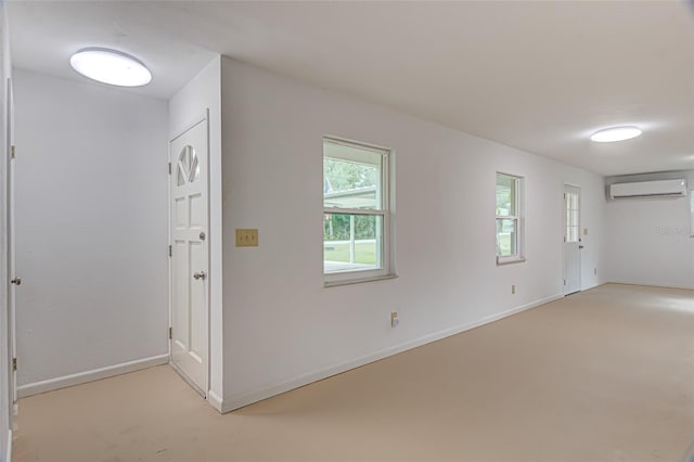 unfurnished room with an AC wall unit