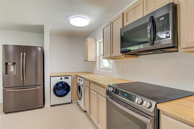 kitchen with light brown cabinets, washing machine and clothes dryer, butcher block countertops, and stainless steel appliances