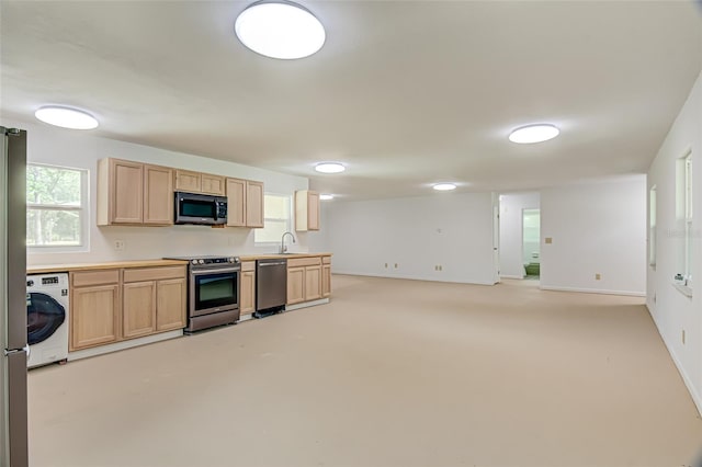 kitchen featuring sink, washer / clothes dryer, light brown cabinetry, and appliances with stainless steel finishes