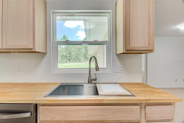 kitchen featuring wooden counters, sink, fridge, and light brown cabinets