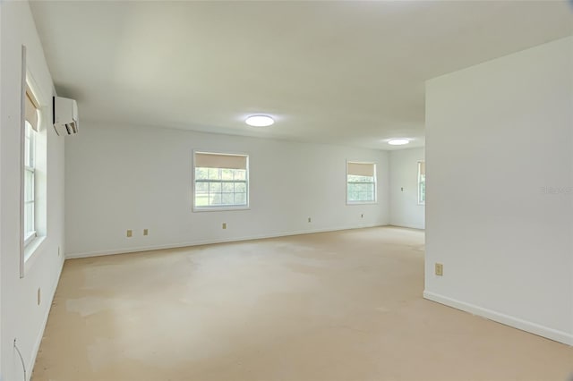 unfurnished room featuring a wall mounted air conditioner