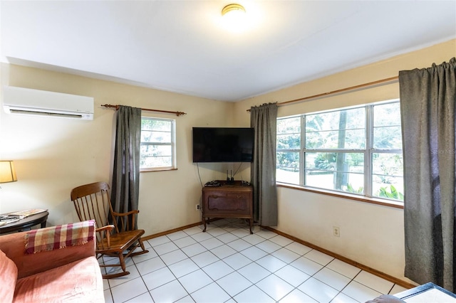 sitting room with a wall mounted AC and light tile patterned floors