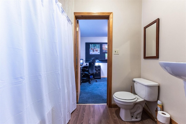 bathroom featuring hardwood / wood-style flooring and toilet