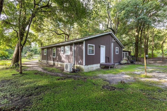 view of side of home with a lawn