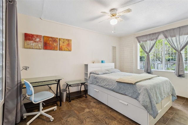 bedroom featuring ceiling fan and dark tile patterned floors