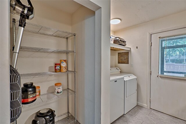 clothes washing area featuring separate washer and dryer and light tile patterned floors