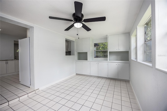 spare room featuring light tile patterned floors and ceiling fan