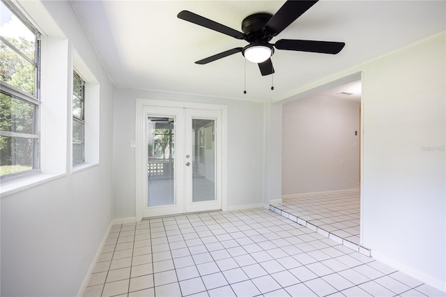 tiled spare room with ornamental molding, french doors, and ceiling fan