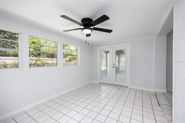 tiled spare room with french doors, ceiling fan, and a healthy amount of sunlight