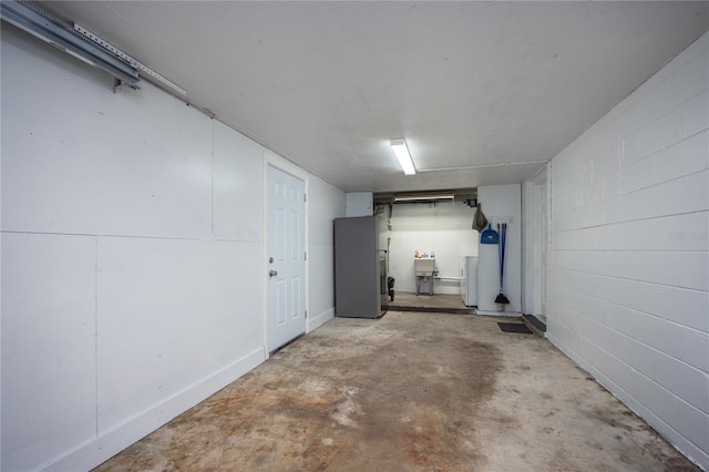 garage with stainless steel fridge and sink