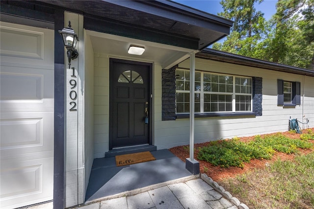 view of exterior entry with a garage