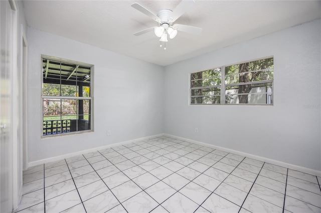 spare room with ceiling fan and a textured ceiling