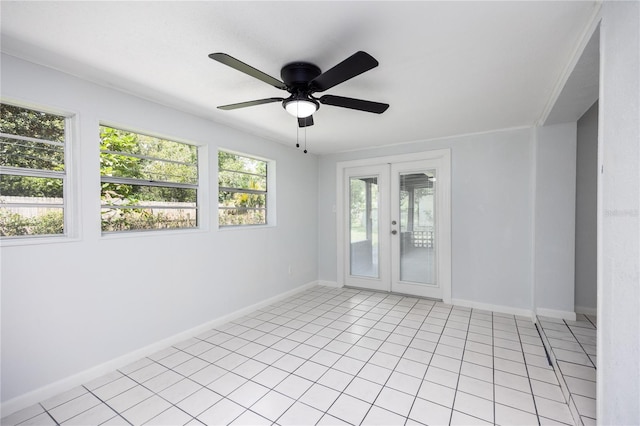 empty room featuring french doors, ceiling fan, baseboards, and light tile patterned floors