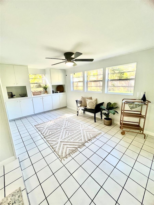 sunroom / solarium with a ceiling fan and a healthy amount of sunlight