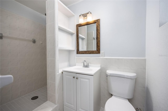 bathroom featuring toilet, a stall shower, tile walls, and wainscoting