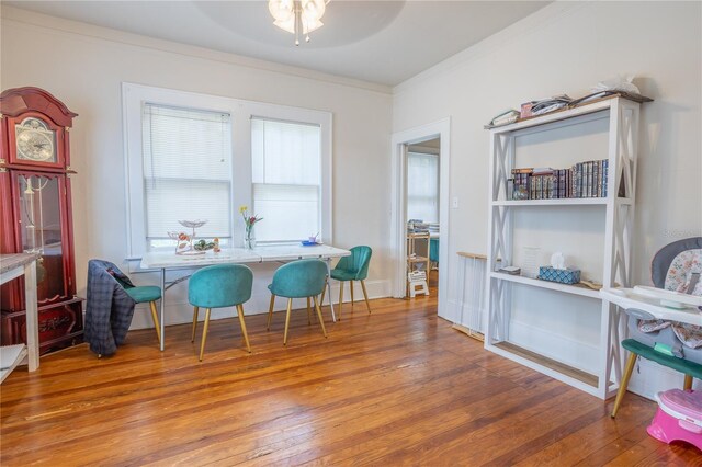 dining space featuring crown molding, hardwood / wood-style flooring, and ceiling fan