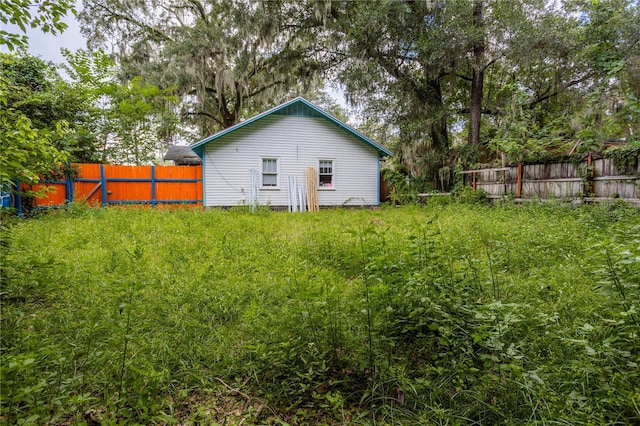 back of house with fence