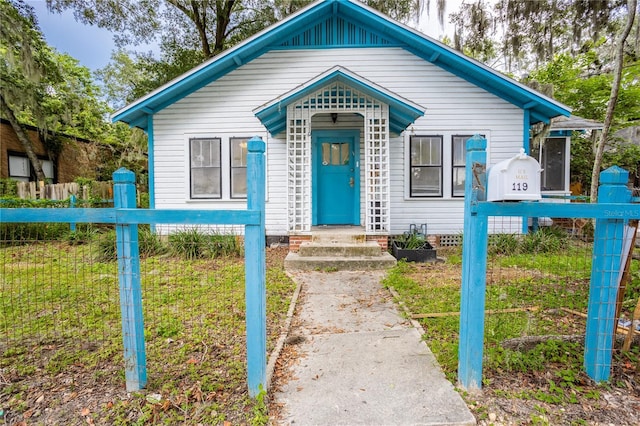 bungalow-style home with fence