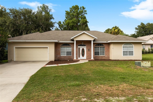 ranch-style house featuring a garage and a front lawn