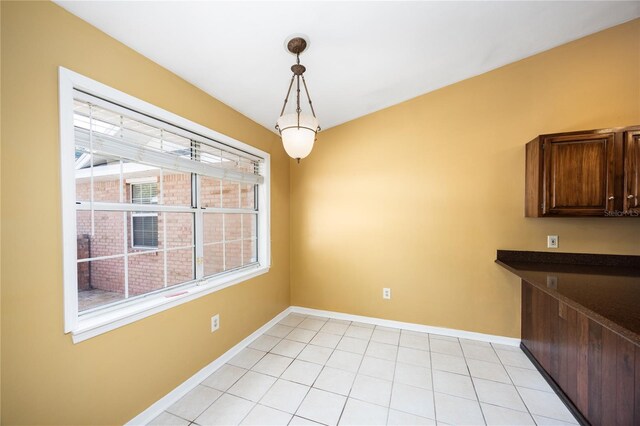 unfurnished dining area with light tile patterned floors