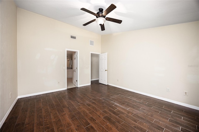 unfurnished bedroom with dark wood-type flooring, ceiling fan, and connected bathroom