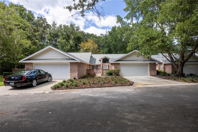 ranch-style house featuring driveway, a garage, and brick siding