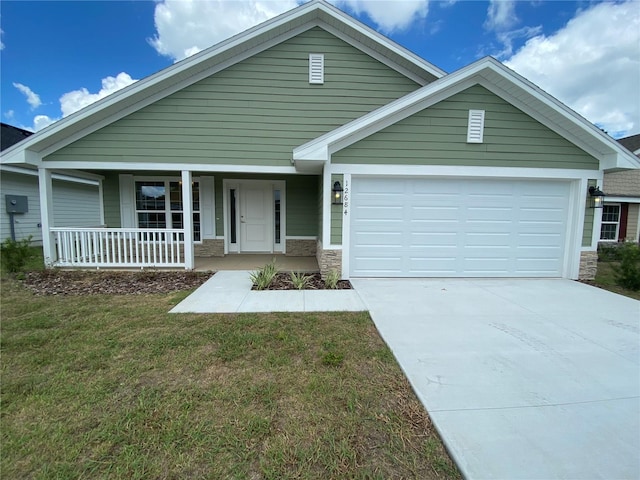 view of front of house featuring a garage, a porch, and a front yard