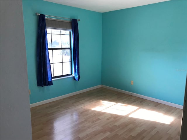 empty room with light hardwood / wood-style flooring